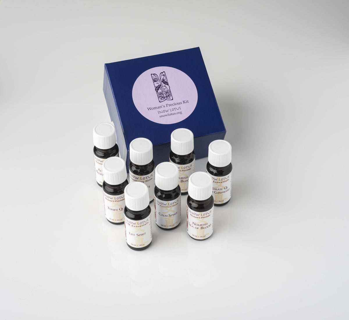 A boxed Snow Lotus kit surrounded by its essential oil bottles