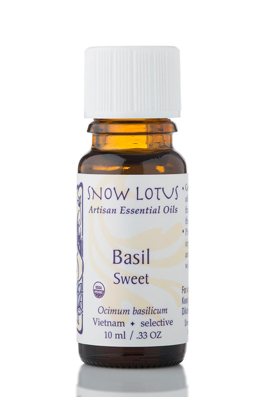 Snow Lotus organic Sweet Basil Essential Oil in an amber glass bottle