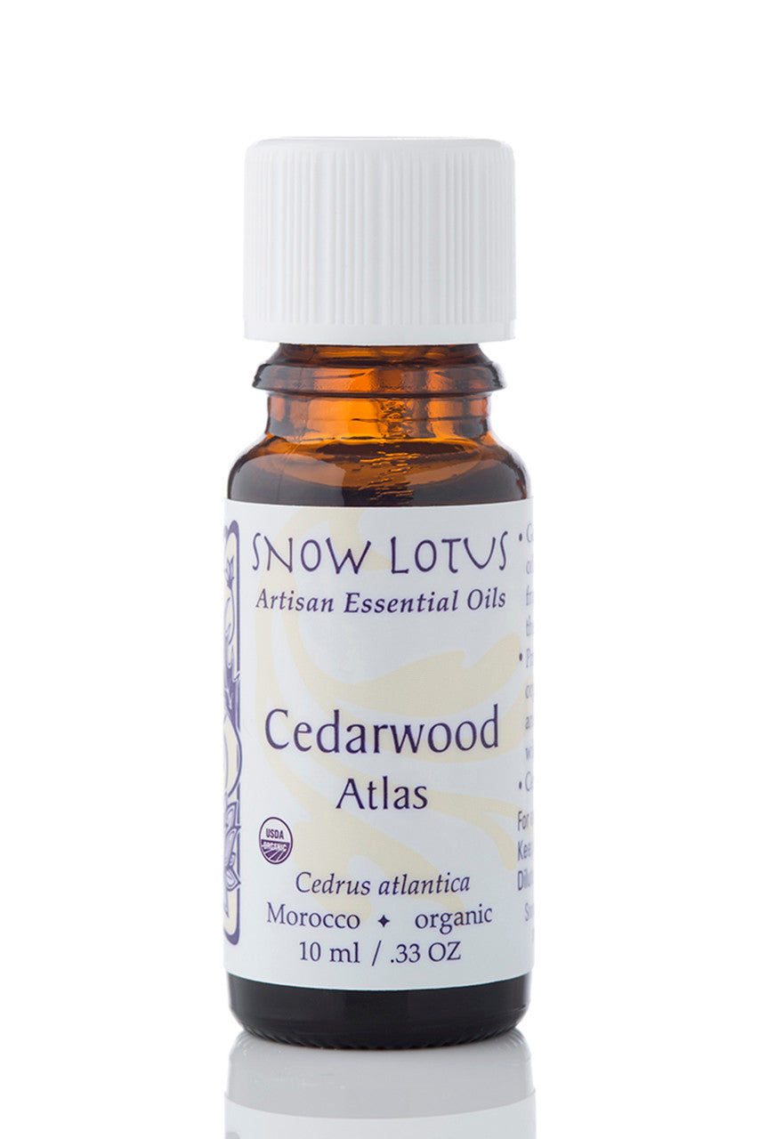 Snow Lotus organic Atlas Cedarwood Essential Oil in an amber glass bottle