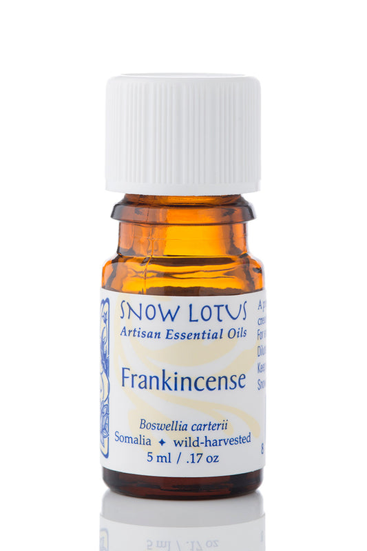 Snow Lotus Frankincense Essential Oil in an amber glass bottle
