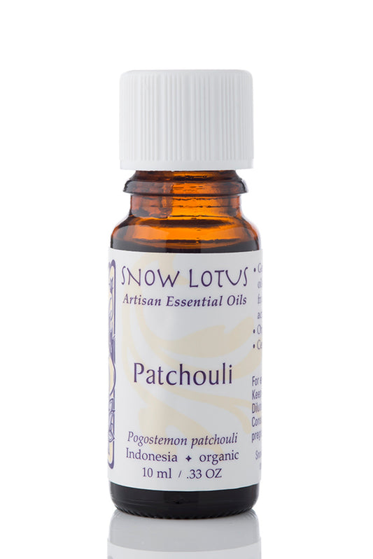 Snow Lotus Patchouli Essential Oil in an amber glass bottle