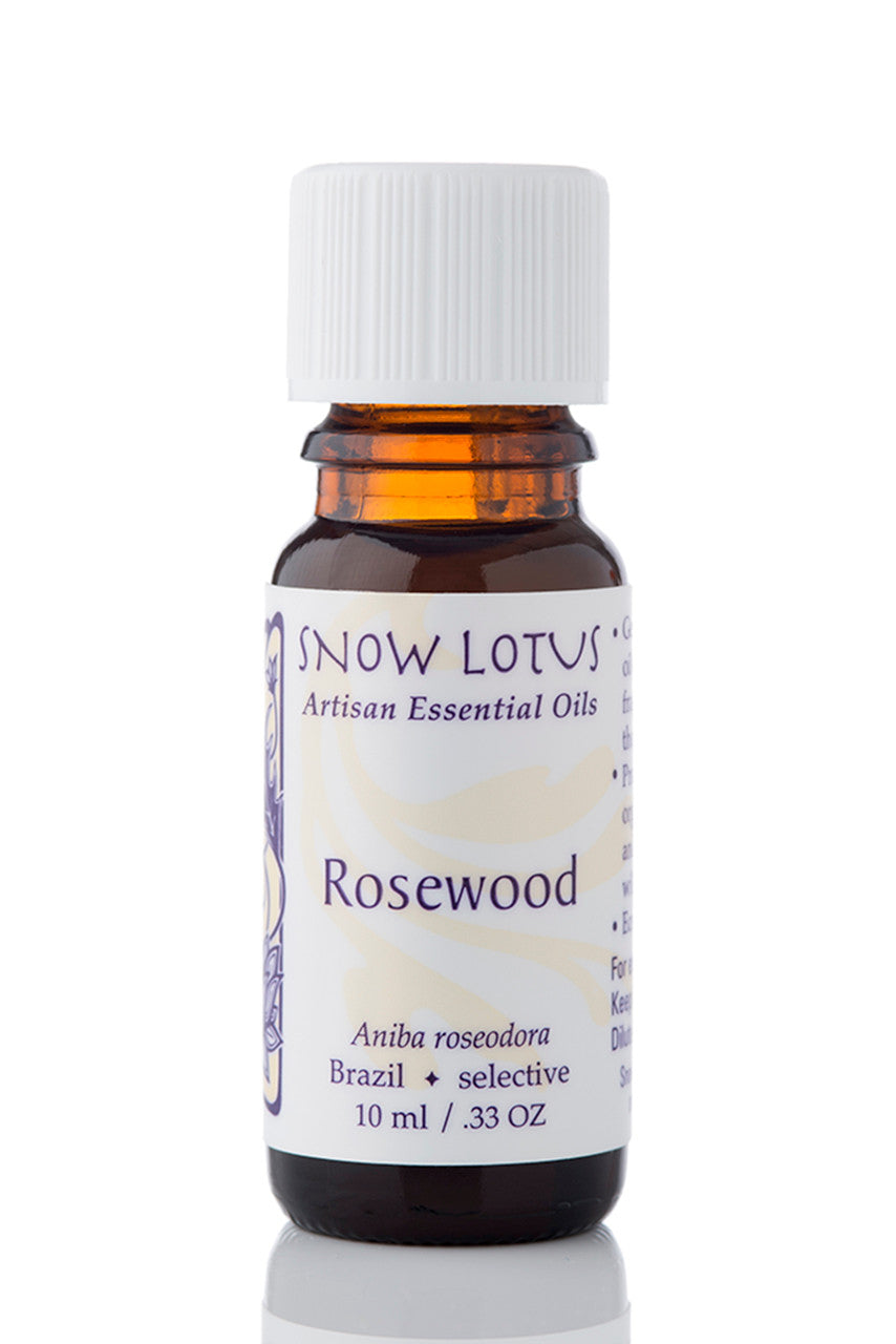Snow Lotus Rosewood Essential Oil in an amber glass bottle