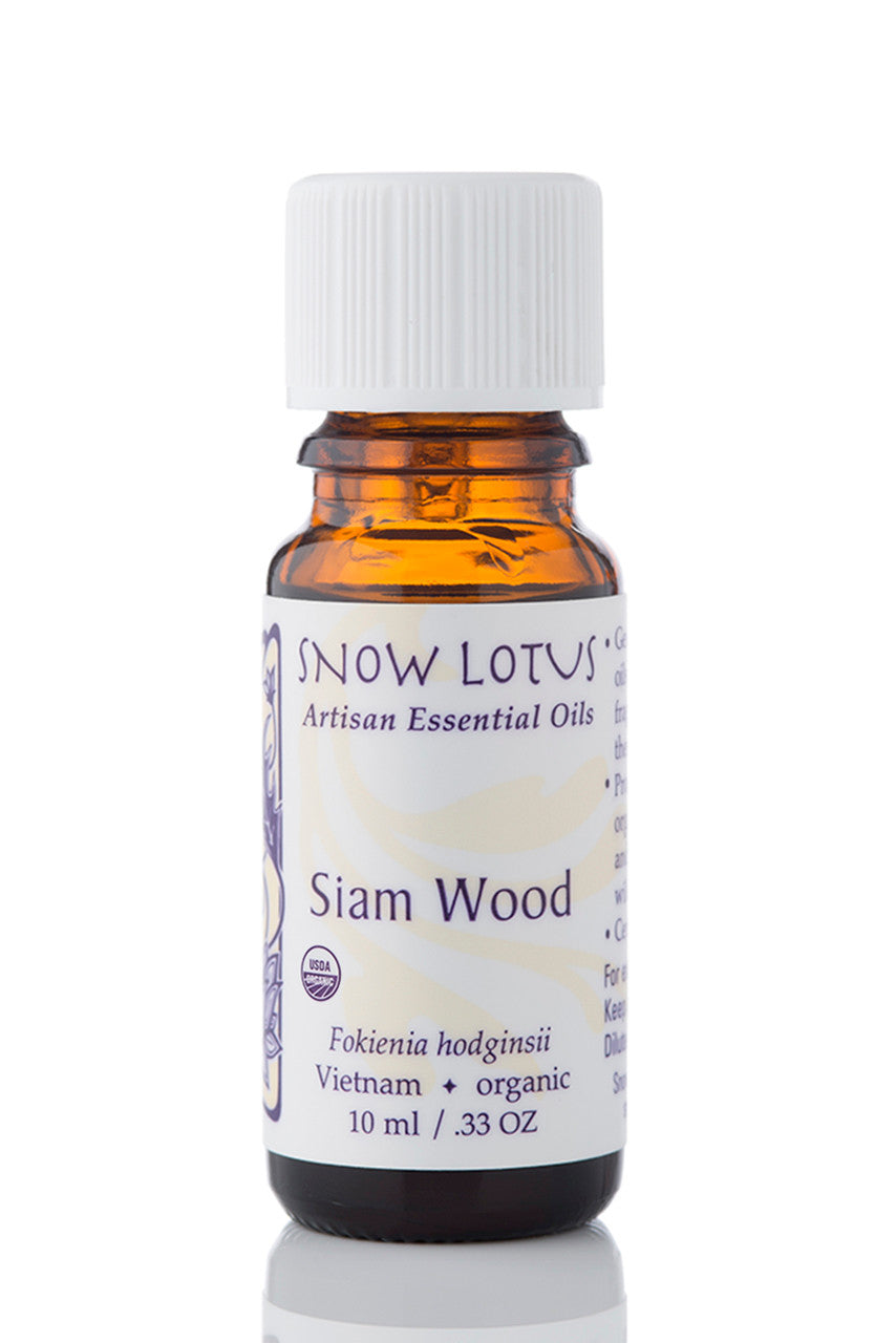 Snow Lotus organic Siam Wood Essential Oil in an amber glass bottle