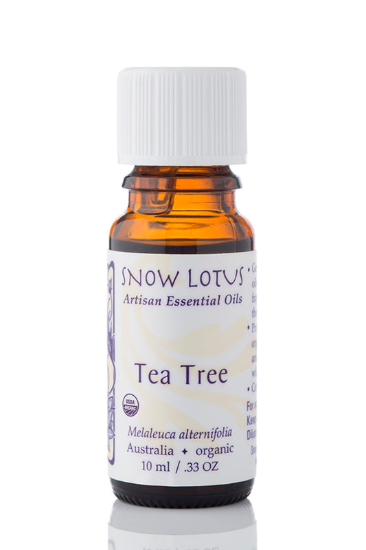 Snow Lotus organic Tea Tree Essential Oil in an amber glass bottle