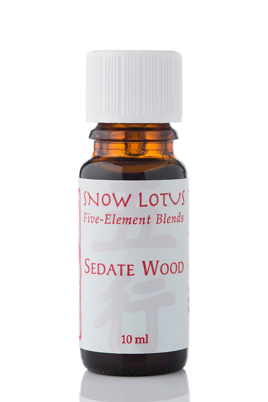 Snow Lotus Sedate Wood - Five Element Essential Oil Blend in an amber glass bottle