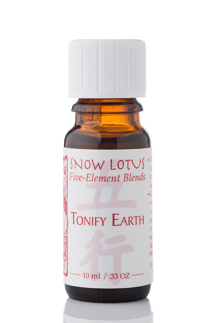 Snow Lotus Tonify Earth - Five Element Essential Oil Blend in an amber glass bottle