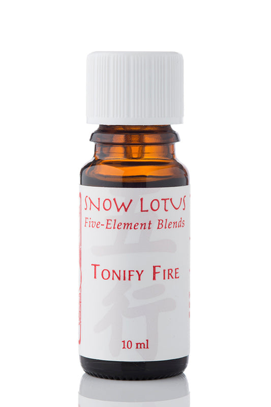 Snow Lotus Tonify Fire - Five Element Essential Oil Blend in an amber glass bottle