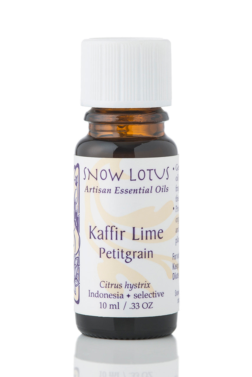 Snow Lotus Kaffir Lime Petitgrain Essential Oil in an amber glass bottle