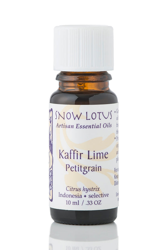 Snow Lotus Kaffir Lime Petitgrain Essential Oil in an amber glass bottle