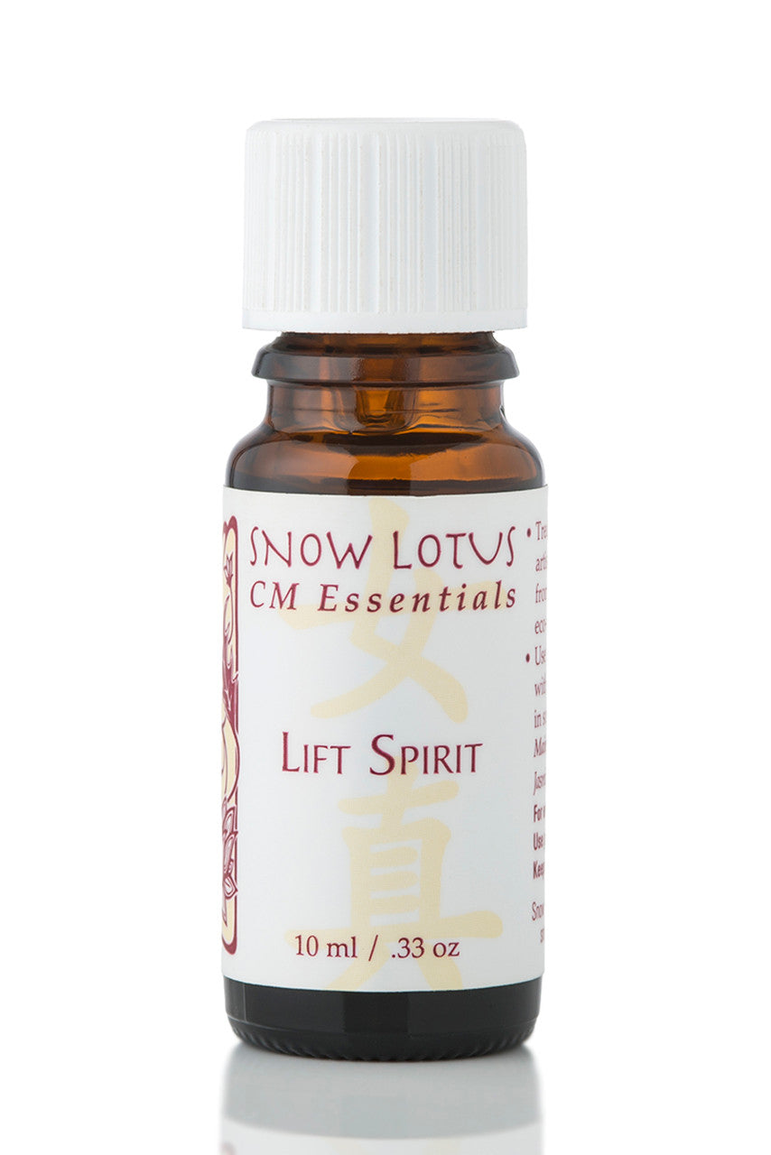 Snow Lotus Lift Spirit - Woman's Precious Blend in an amber glass bottle